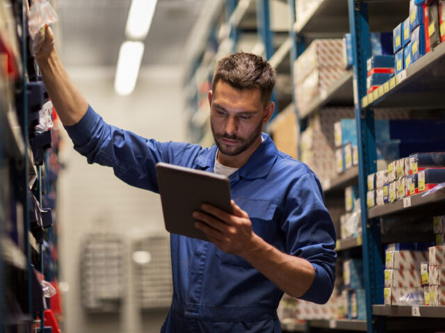 auto mechanic or smith with tablet pc at workshop